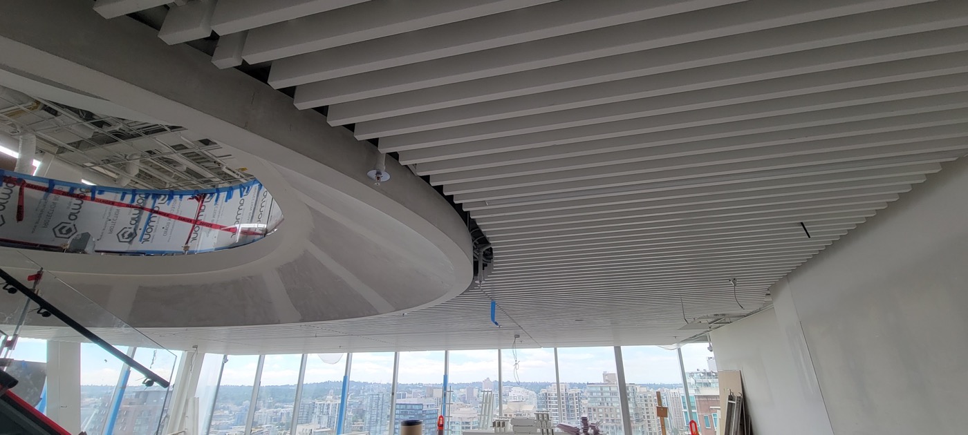 Curved linear ceiling feature following a circular opening. Curved linear ceiling feature following a circular opening.