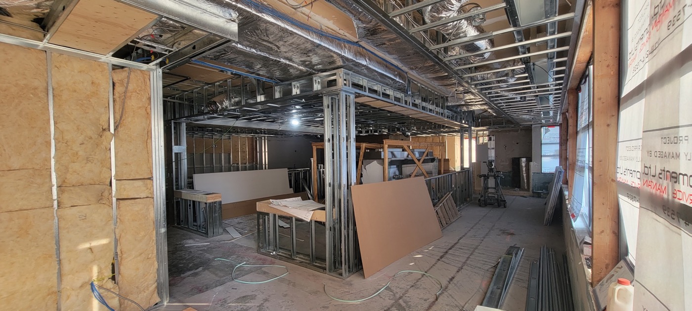 Commercial tenant improvement with framing and ceiling services exposed during construction. Commercial tenant improvement with framing and ceiling services exposed during construction.