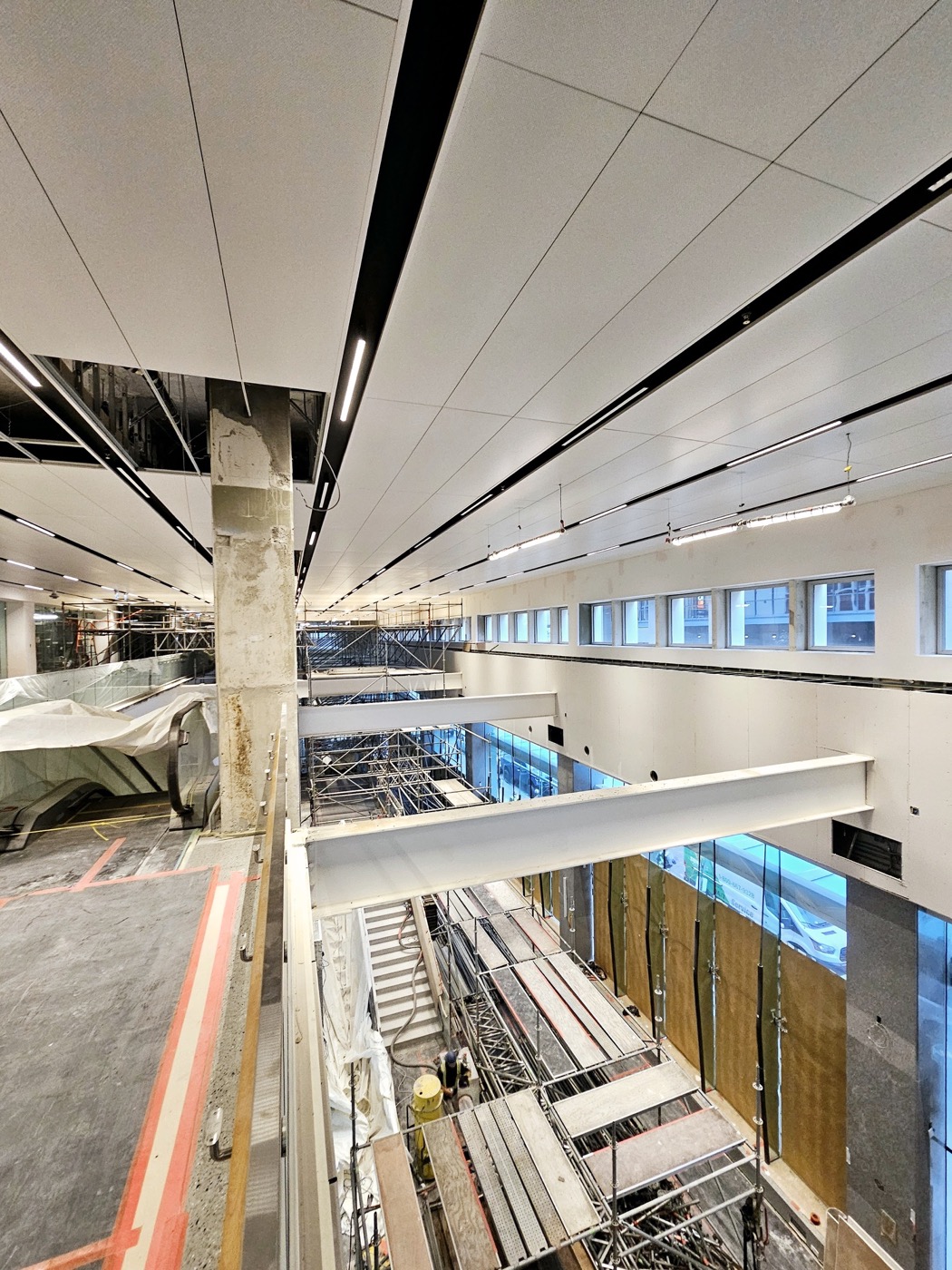 Large-format suspended ceiling panels installed along a commercial interior. Large-format suspended ceiling panels installed along a commercial interior.