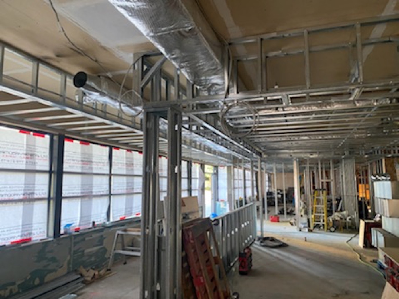 Light-gauge steel stud walls and ceiling framing installed in a commercial interior. Light-gauge steel stud walls and ceiling framing installed in a commercial interior.